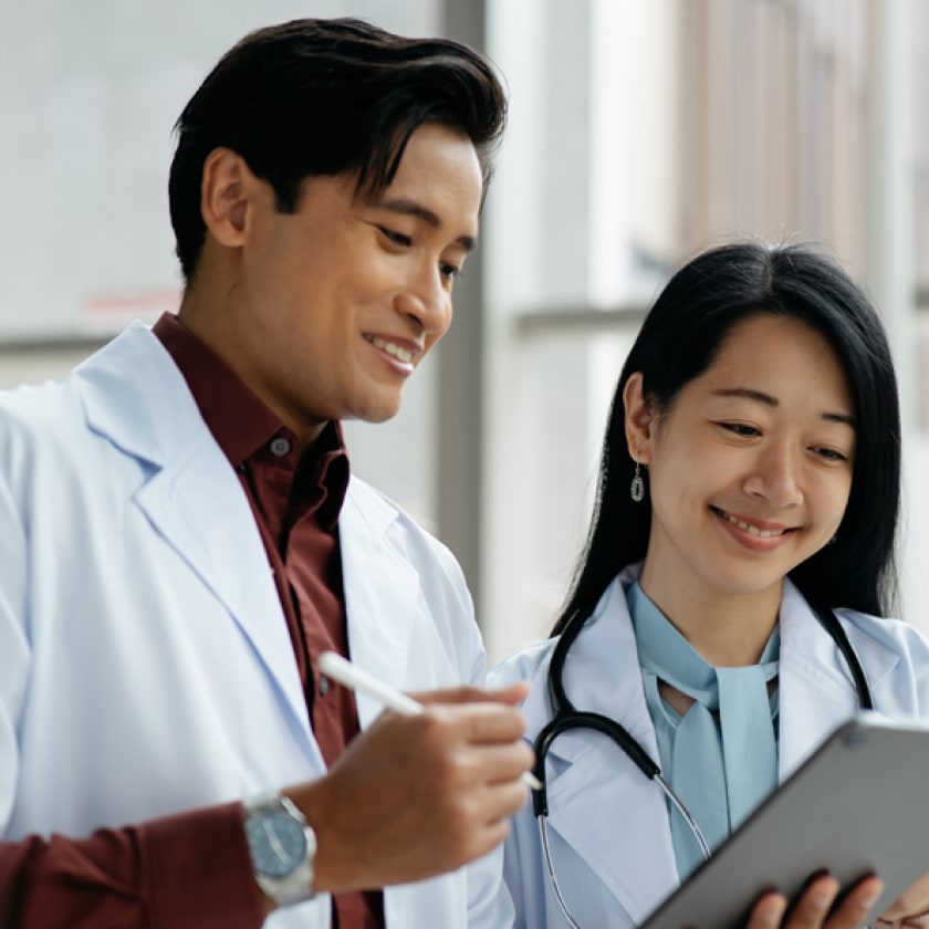 Two doctors looking at a tablet together